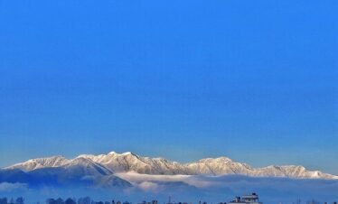 Snow-capped Himalayan mountains overlooking Kathmandu Valley cityscape in Nepal