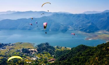 Soar above Pokhara's stunning Phewa Lake—one of the world's best paragliding destinations.