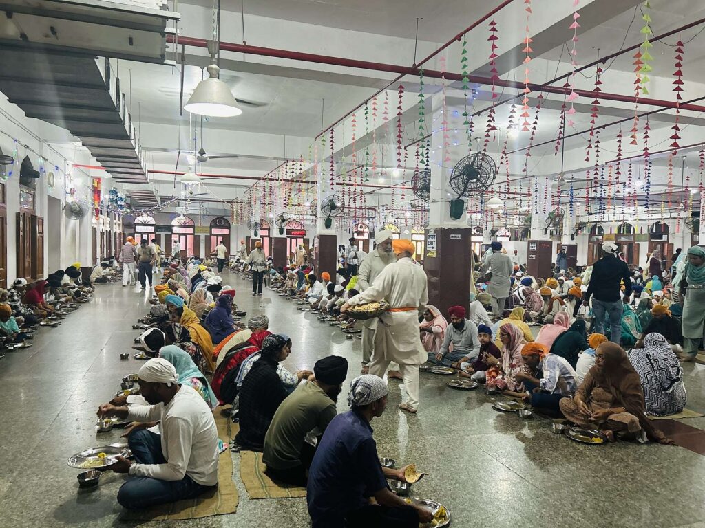 Pilgrims eating together in the langar kitchen at the Golden Temple, Amritsar