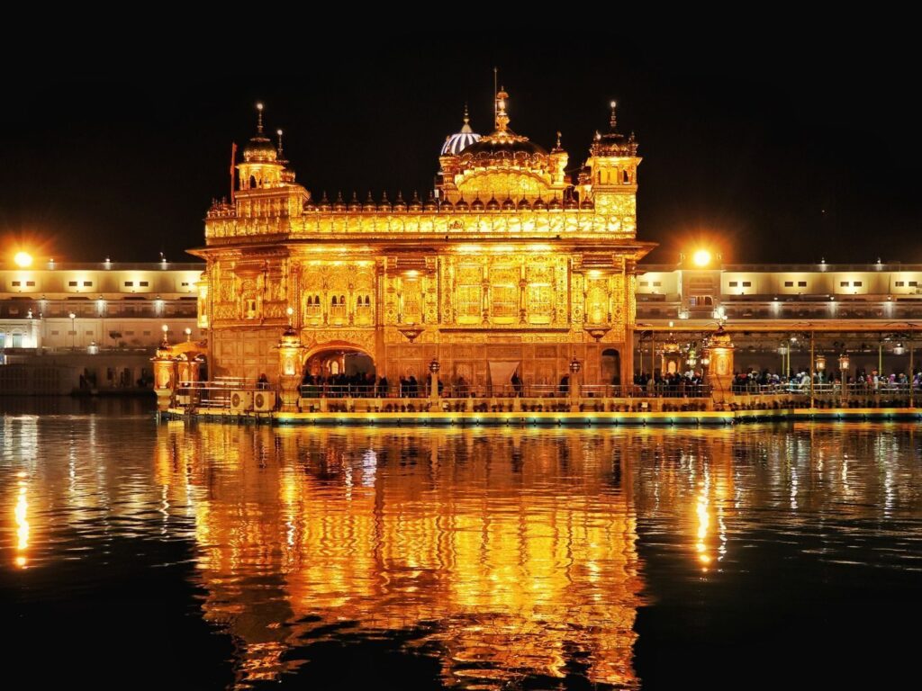 The Golden Temple at Amritsar lit up and reflected in the sacred pool at night