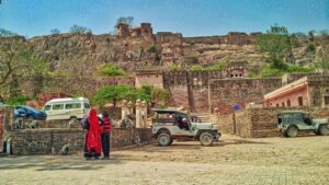 Visitors and safari vehicles below the walls of Ranthambore Fort, Rajasthan