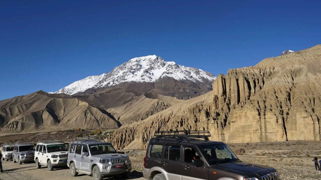 Four-wheel-drive jeeps on the desert road through Upper Mustang