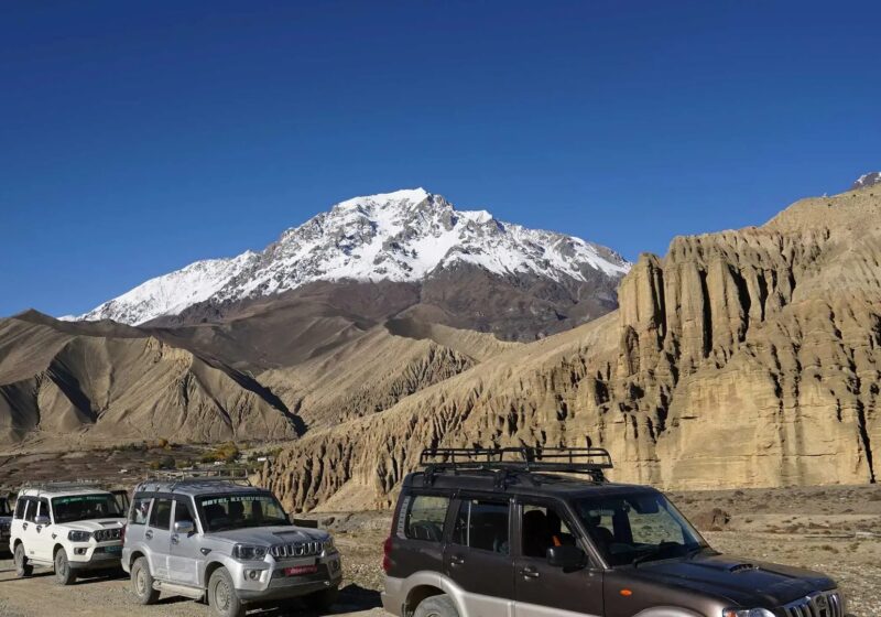 Four-wheel-drive jeeps on the desert road through Upper Mustang
