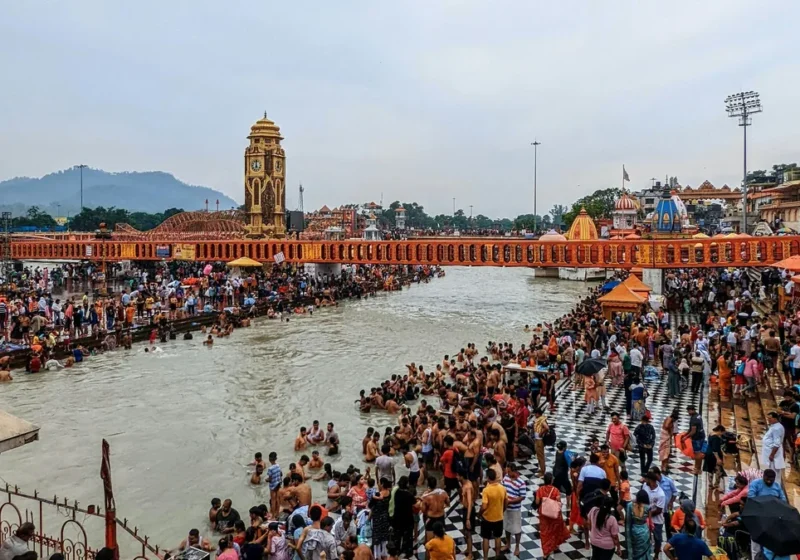 Pilgrims and the Ganga at Har Ki Pauri ghat in Haridwar with temple towers