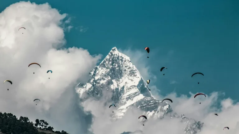 Paragliders in front of Machhapuchhre above Pokhara on a Nepal tour