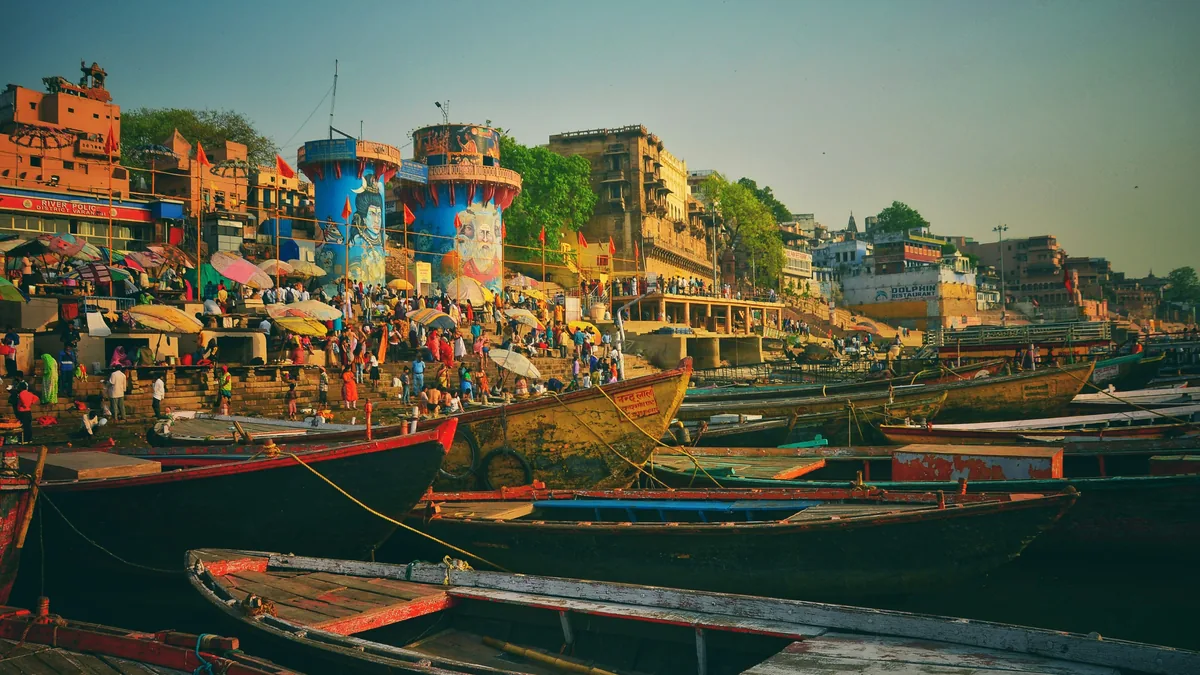 Varanasi Ghats at Dawn – India–Nepal Pilgrimage Guide India–Nepal pilgrimage: wooden boats on the Ganga in front of the ghats of Varanasi at dawn