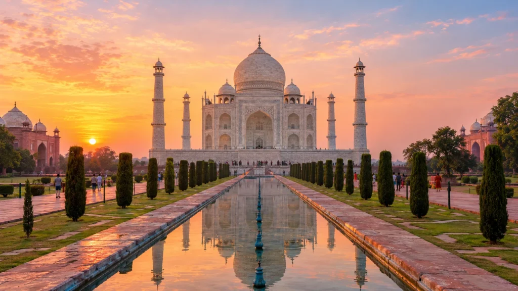 The Taj Mahal at sunrise reflected in the long pool between cypress trees, Agra, Golden Triangle tour