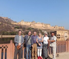 Our travelers exploring the magnificent Amber Fort in Jaipur with their local guide. Tourist group with local guide posing in front of Amber Fort in Jaipur, Rajasthan India