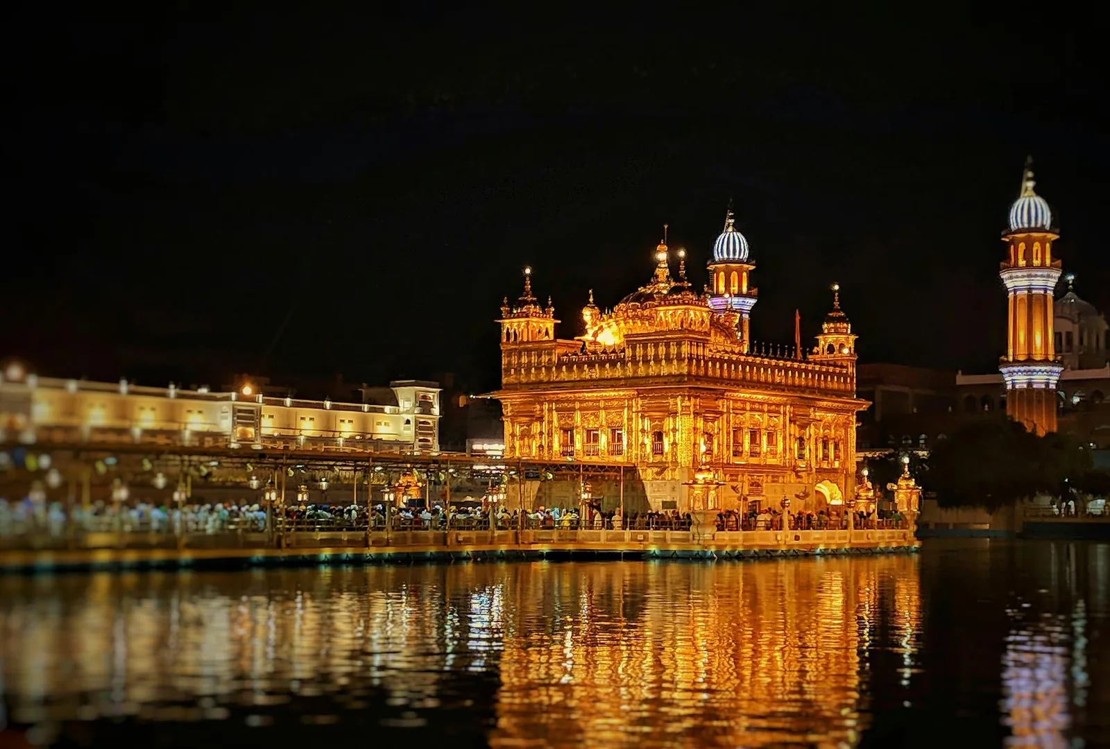 The Golden Temple illuminated at night, reflected in the sarovar, Amritsar