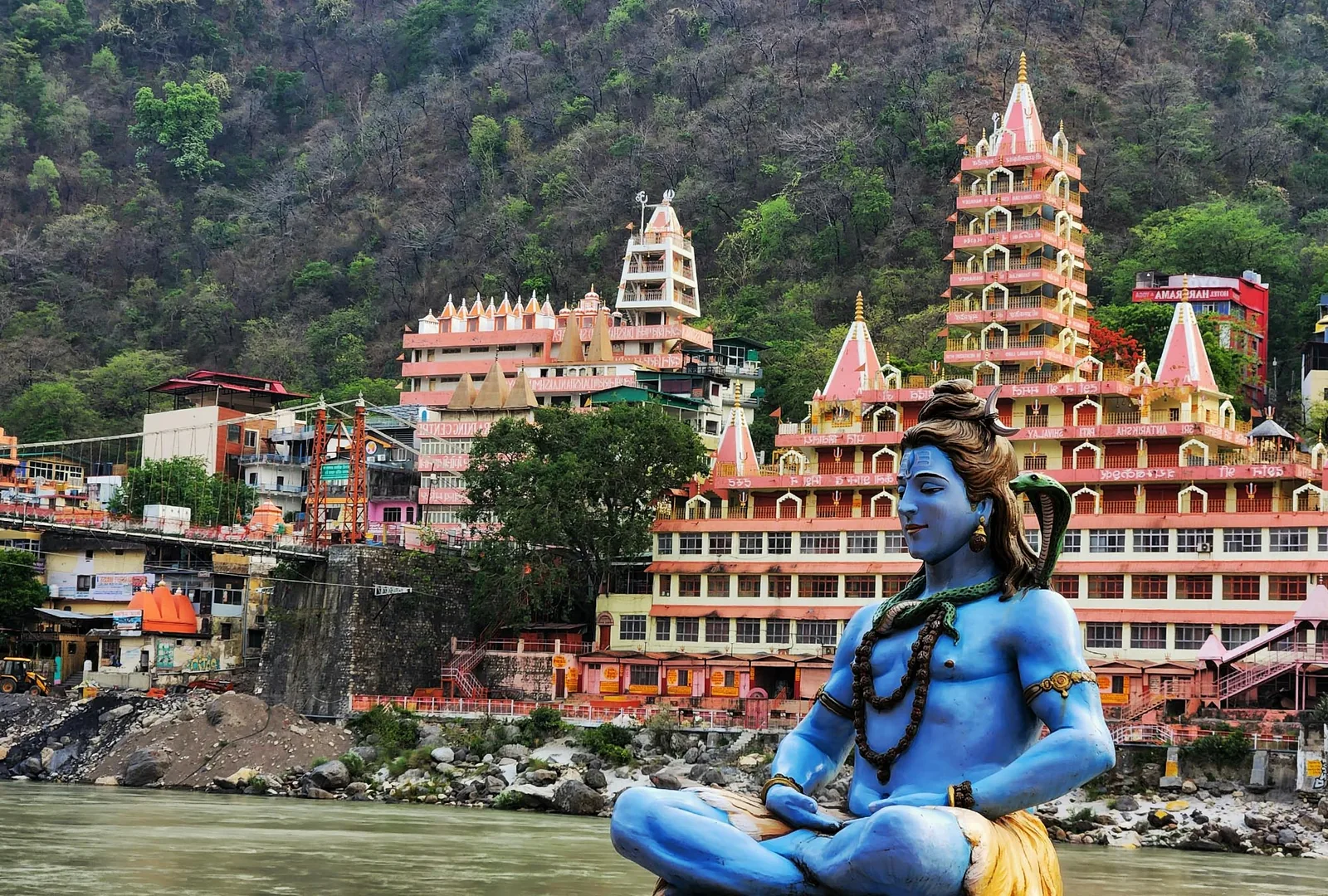 Riverside temples and the Shiva statue on the Ganges at Rishikesh